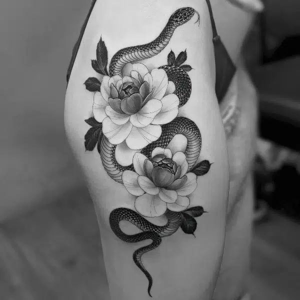 realism tattoo of snake and flower