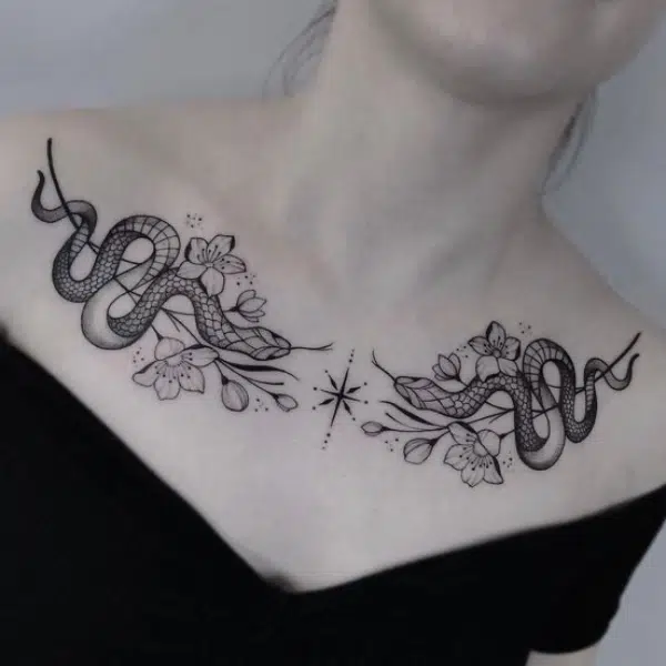 flower and snake tattoo on collarbone